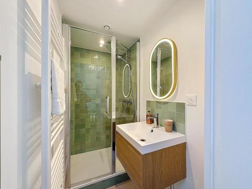 a bathroom with a sink and a shower at L'intemporel YourHostHelper in Deauville