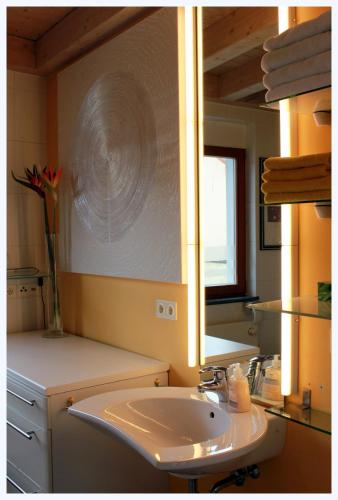 a bathroom with a sink and a mirror at Studio A Am Burgberg in Erlangen