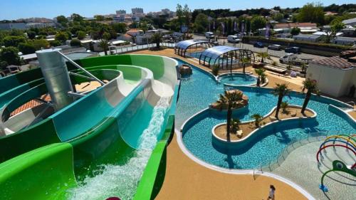 a water park with a water slide and a water slide at Mobil-home 33 st jean de monts camping 5 étoiles in Saint-Jean-de-Monts