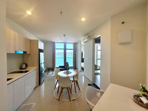 a kitchen and living room with a table and chairs at The Shore LW Premium Suites KK Downtown in Kota Kinabalu
