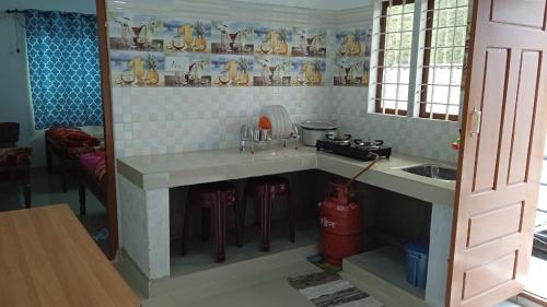 a toy kitchen with a counter and a sink at Shobha home stay in Vattavada