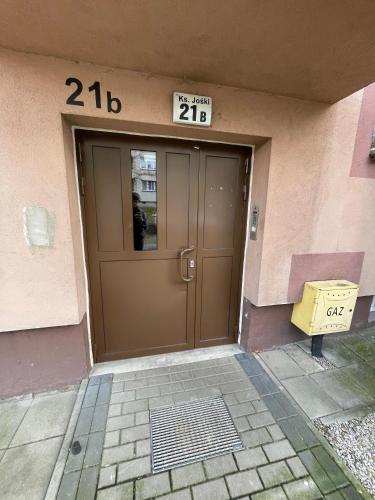 a front door of a building with a sign on it at Apartament Jośki in Rybnik