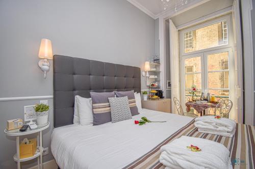 a bedroom with a large bed with flowers on it at B in B Douradores in Lisbon
