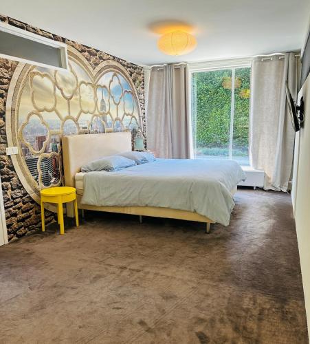a bedroom with a bed and a wall with a mural at Villa Vista in Wassenaar