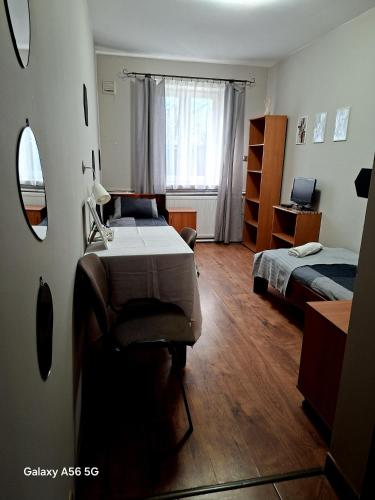 a bedroom with two beds and a desk and a mirror at K14 Rooms Lublin in Lublin