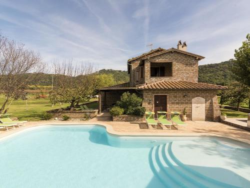 a villa with a swimming pool in front of a building at Apartment Casa Ricardo n- 4 by Interhome in Montefiascone