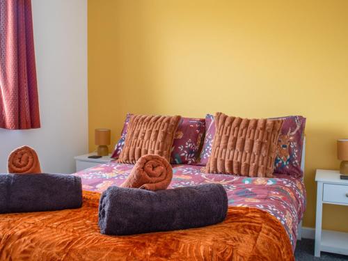 a bedroom with a bed with two donuts on it at Holiday Home Alan's House by Interhome in Staffin