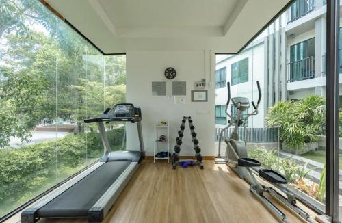 a gym with two treadmills and a treadmill at Z cape 1 one one in Laguna Phuket
