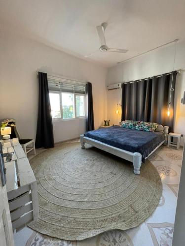 a bedroom with a large bed and a large rug at B4 Apartment Stone Town in Zanzibar City
