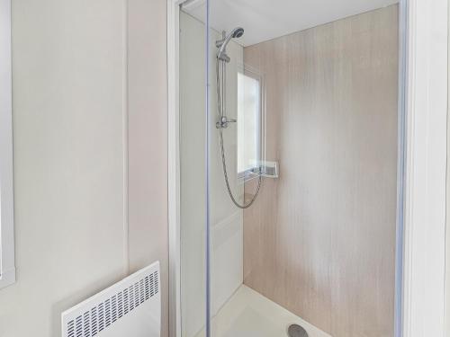 a shower with a glass door in a bathroom at Green harmony in Litteau