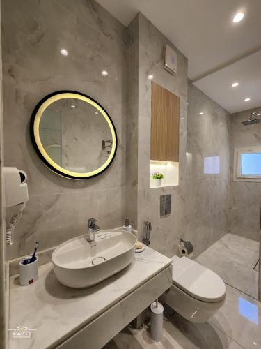 a bathroom with a sink and a toilet and a mirror at Solpyramid Hotel in Cairo