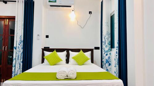 a bedroom with a bed with two white slippers at Casamia Tangalle - Relaxing Cozy Homestay Hiriketiya in Sinimodera