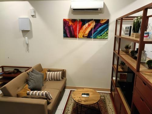 a living room with a couch and a table at Timurbay Residence Resort Style in Kuantan