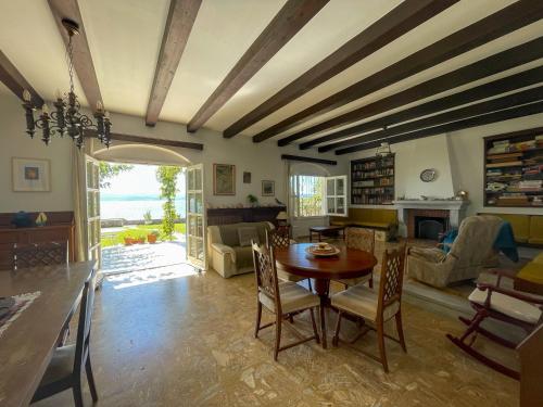 a living room with a wooden table and chairs at Beachfront Family Villa in Eretria