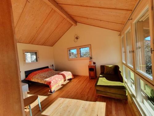 a bedroom with a bed and a couch at Garden Oasis In Bern in Liebefeld