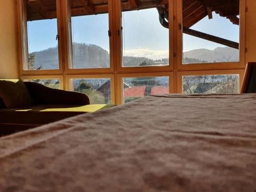 a room with a large window with a bed and a couch at Garden Oasis In Bern in Liebefeld