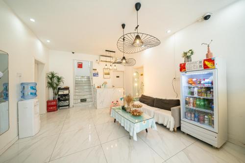 a living room with a refrigerator filled with drinks at Shanghai Star Dream Hotel in Shanghai