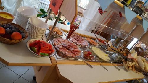 a buffet with many different types of food on a counter at Rosa Bed and Breakfast in Podgorje