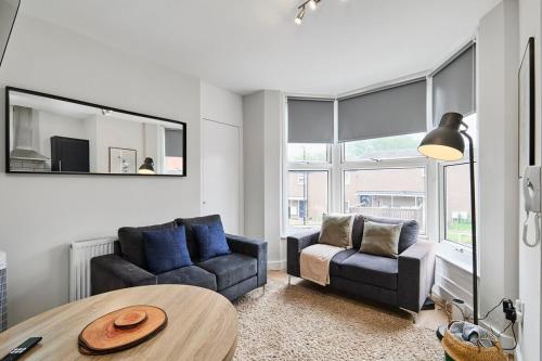 a living room with a couch and a table at Kendal Lane Apartments in Central Station