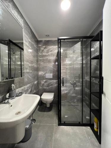 a bathroom with a shower and a sink and a toilet at Hotel Mille Kaleiçi in Antalya