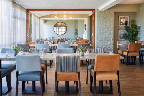 a restaurant with tables and chairs in a room at Bells Hotel in Coleford