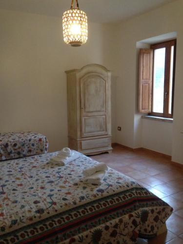 a bedroom with a bed and a chandelier at Locanda Marzi in Faicchio