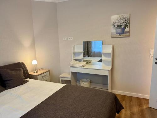 a bedroom with a bed and a desk with a book at Schöne Wohnung 1 in Buchholz in der Nordheide