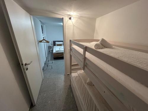 a bedroom with a bed and a door to a room at Gemütliche Souterrainwohnung mit gratis Parkplatz in St. Gallen