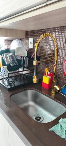a kitchen counter with a sink and a sink at BEACH HOUSE ARUANA in Aracaju