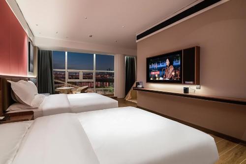 Postel nebo postele na pokoji v ubytování Xili Tiancheng Hotel Nanbin Road Branch