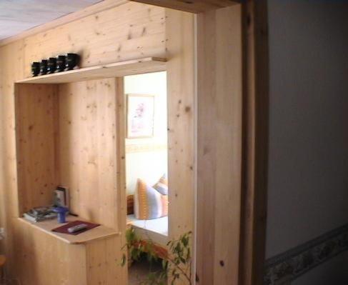 a room with a wooden wall with a mirror at Ferienwohnung Lotti in Brotterode-Trusetal