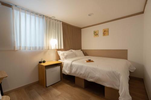 a hotel room with a bed and a window at stay105행궁 in Suwon