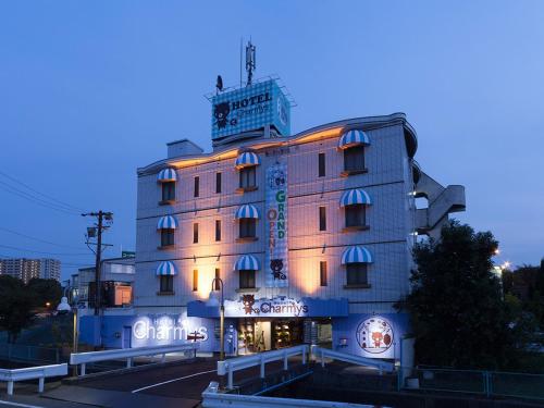 a building with a clock tower on top of it at Hotel Charmies Meito - Adult Only in Nagoya