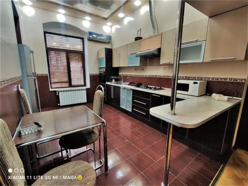 Una cocina con una mesa y algunas sillas. en Urban Inn Hostel, en Baku