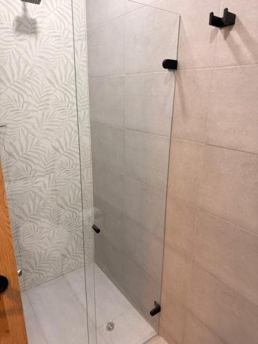 a shower with a glass door in a bathroom at Apartamento Suite Chía Solar 228 in Chía