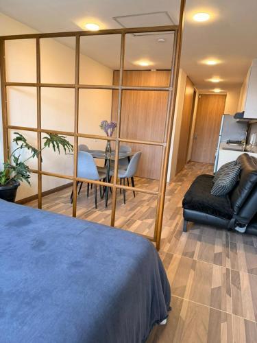 a room with a bed and a table and chairs at Apartamento Suite Chía Solar 228 in Chía