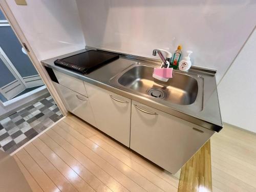 a small kitchen with a sink in a room at 410札幌駅徒歩7分と大通駅徒歩6分で好立地な都心を満喫でき綺麗な部屋で快適が生活が実現 in Sapporo