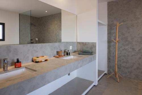 a bathroom with two sinks and a mirror at Modern villa - 4 luxury suites - Golf Amelkis - Marrakech in Marrakech