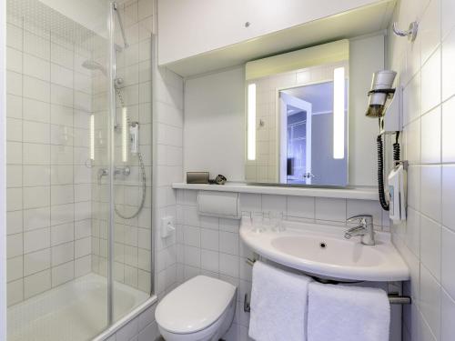 a bathroom with a sink and a toilet and a shower at ibis Berlin Mitte in Berlin