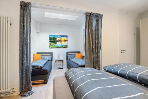 a living room with two beds and a mirror at City Apartment in Uelzen