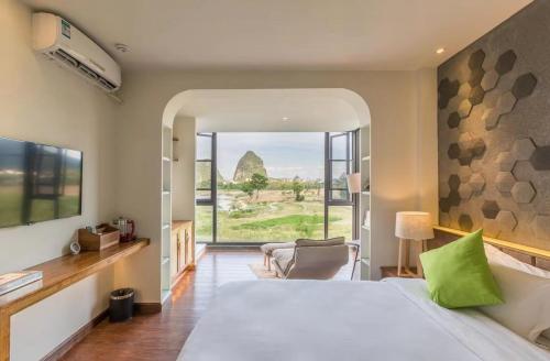 a bedroom with a large bed and a large window at Guilin cozy mountain retreat in Guilin
