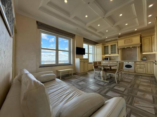 a large living room with a couch and a table at Дельмар Люкс in Dnipro