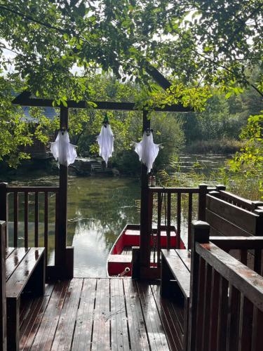 a boat sitting on the water next to a dock at Cabane atypique sur une Île in Sury-aux-Bois