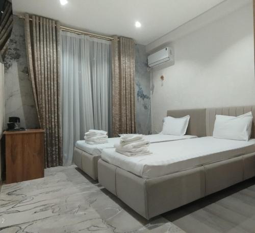 a bedroom with two beds with towels on them at Intercity Hotel Tashkent by Maskan in Tashkent