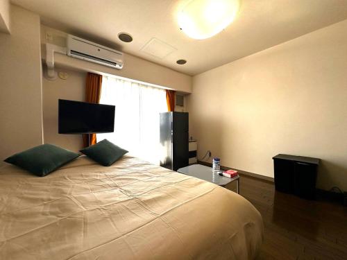 Ένα ή περισσότερα κρεβάτια σε δωμάτιο στο 9-5 NEW OPEN　美室駅近で眺望良好　駐車場予約可