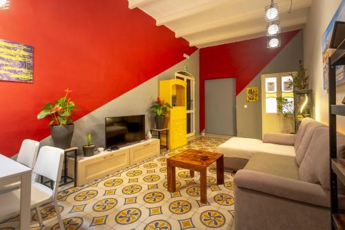 a living room with a red wall at Ensuite budget twin room at quiet and friendly townhouse in Sliema