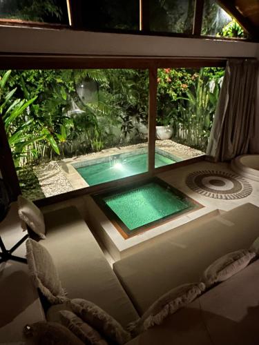 a view of a swimming pool through a window at BaraJade Villas in Uluwatu