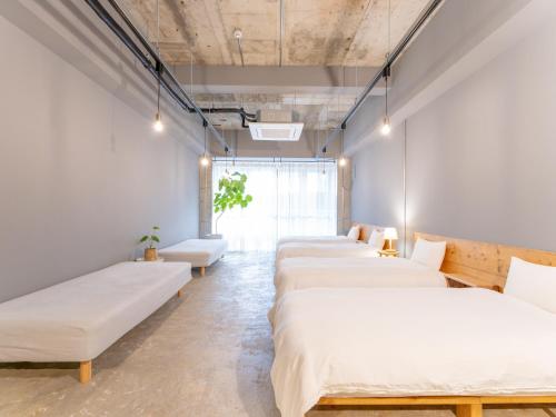 a row of beds in a room at Hotel art rock in Takamatsu