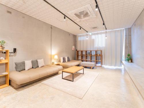 a living room with a couch and a table at Hotel art rock in Takamatsu