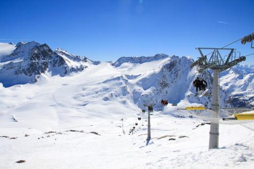 a ski lift with people on it on a snowy mountain at Residence Remi in Senales